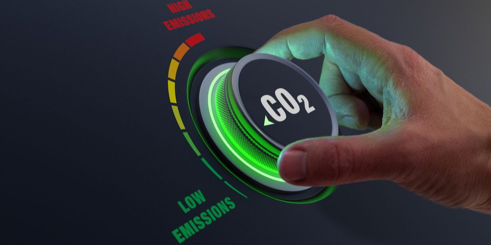 A hand turns a CO2 dial towards the low emission setting